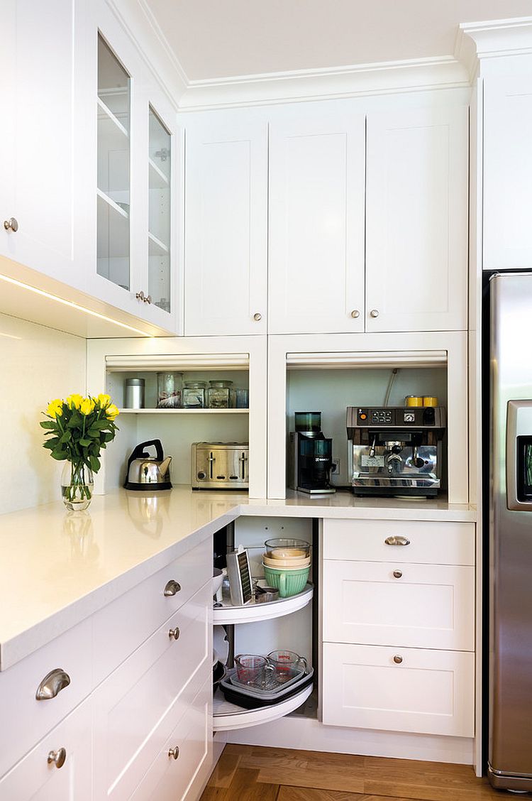 Stylish, open corner shelves replace the traditional drawers in this kitchen [Design: Kitchens by Peter Gill]