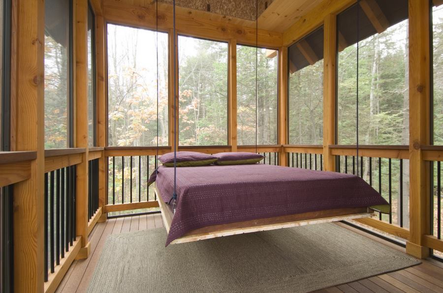 Suspended bed on a screened-in sleeping porch