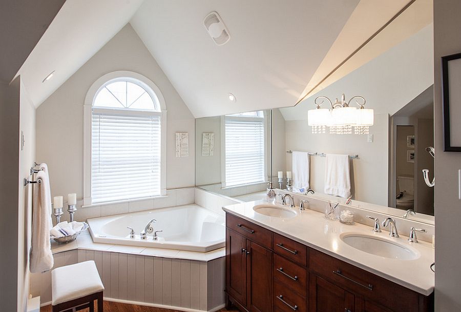 Tiny bathroom with bathtub next to the window