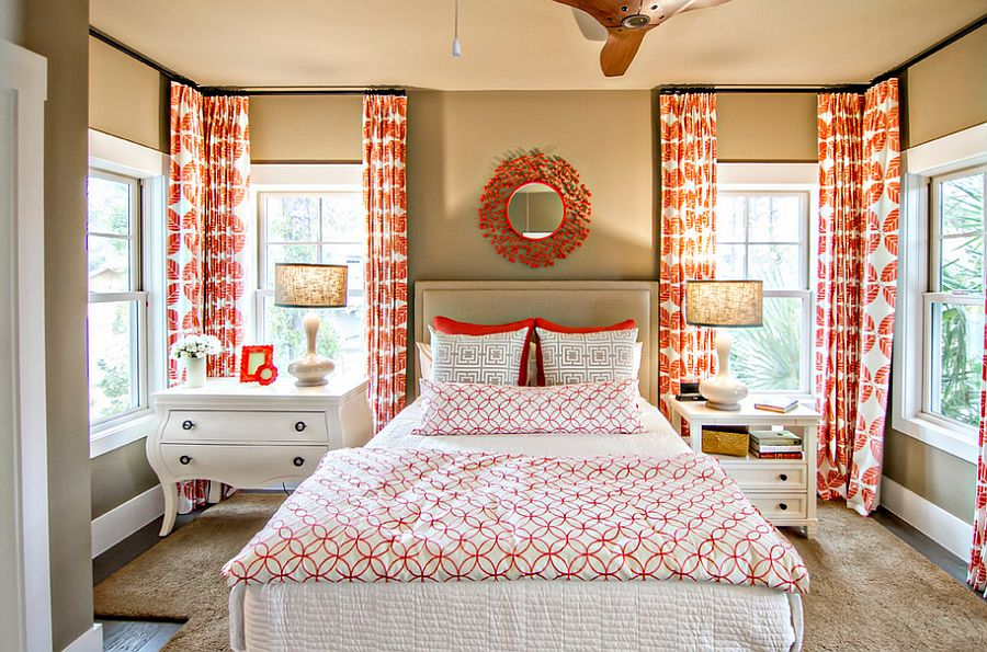 Tropical bedroom with pops of orange and mismatched nightstands [Design: Glenn Layton Homes]