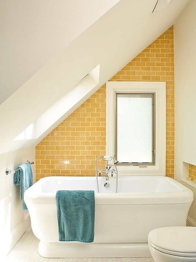 Tub with yellow brick wall in attic