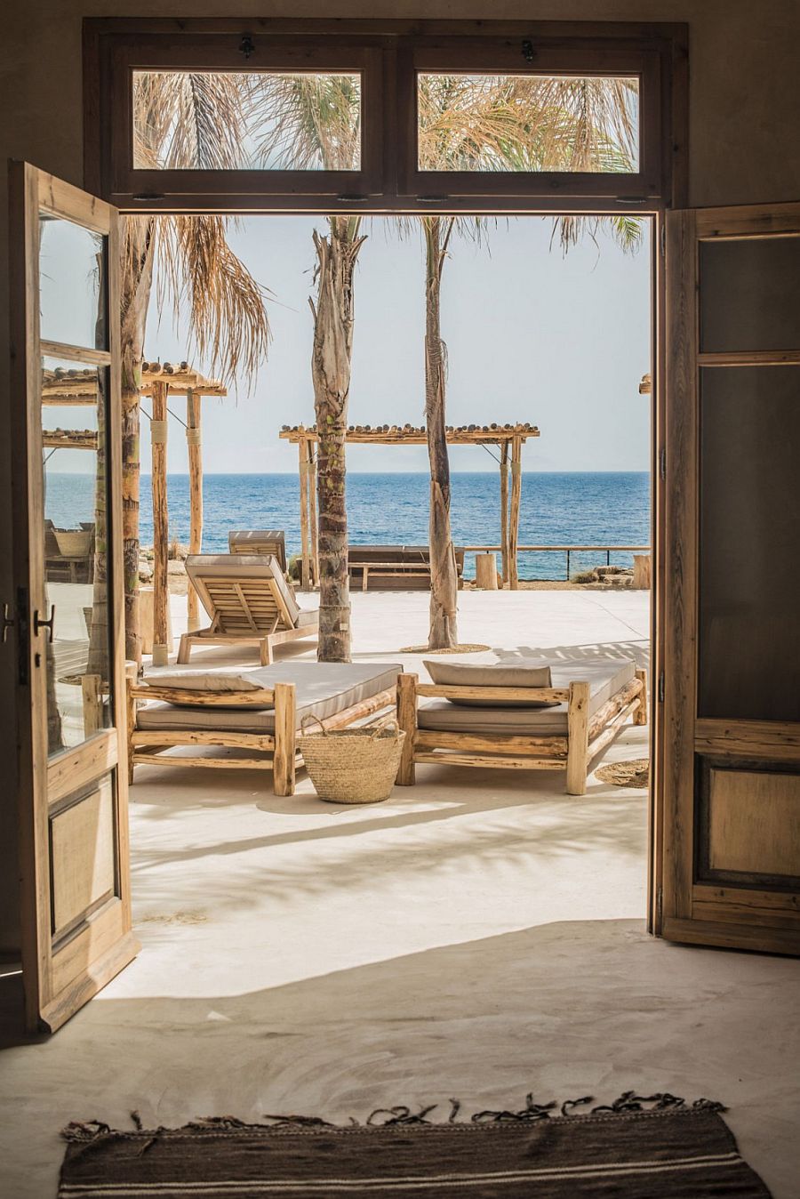 View of the blue sea and the outdoor retreats from the villas