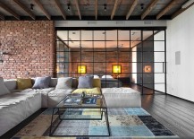 Wall-of-glass-separates-the-living-room-from-the-bedroom-inside-the-bachelor-loft-217x155