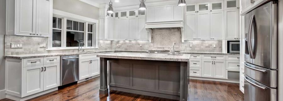 White granite in a white kitchen with metallic tones