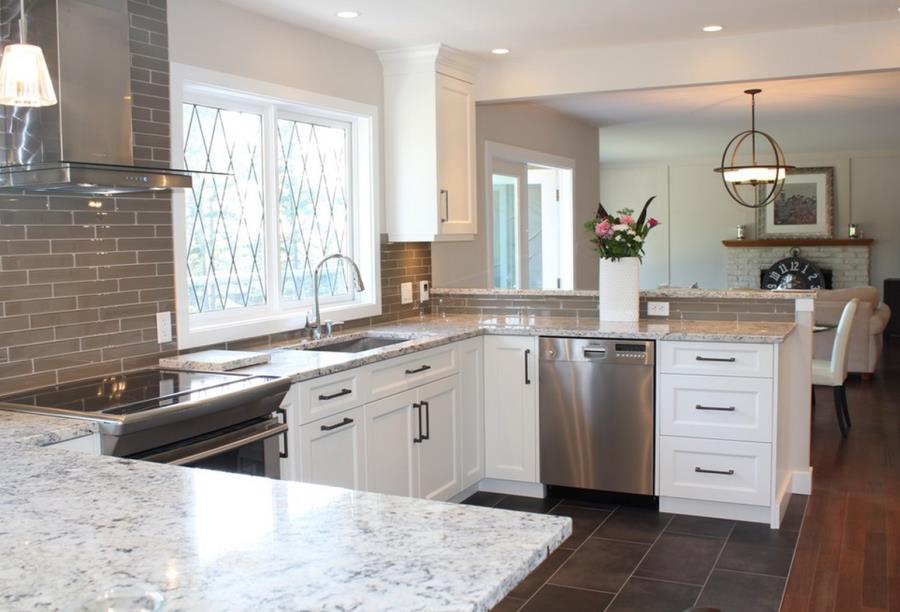 White ice granite in a kitchen with grey tile