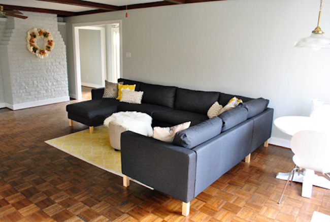 Yellow area rug paired with black furniture