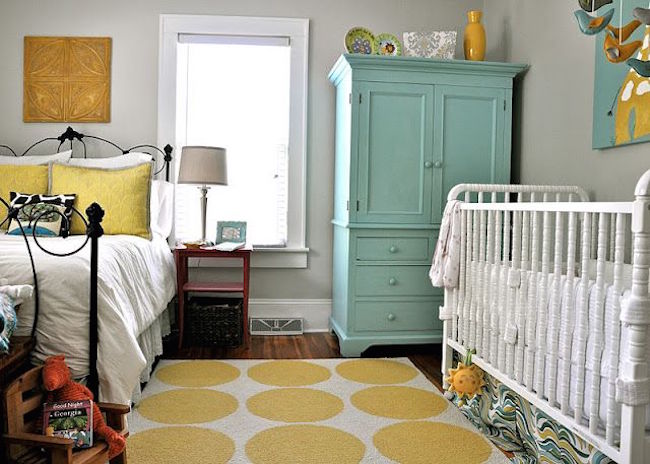 Yellow spherical rug separates a shared bedroom space