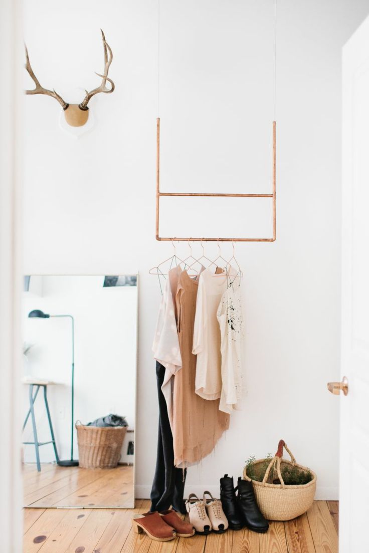 Small geometric structure hung from ceiling for clothing storage