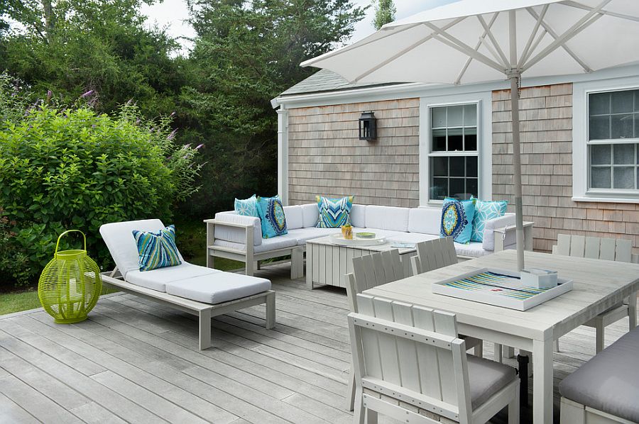 All-white outdoor decor for the deck with light blue accent pillows