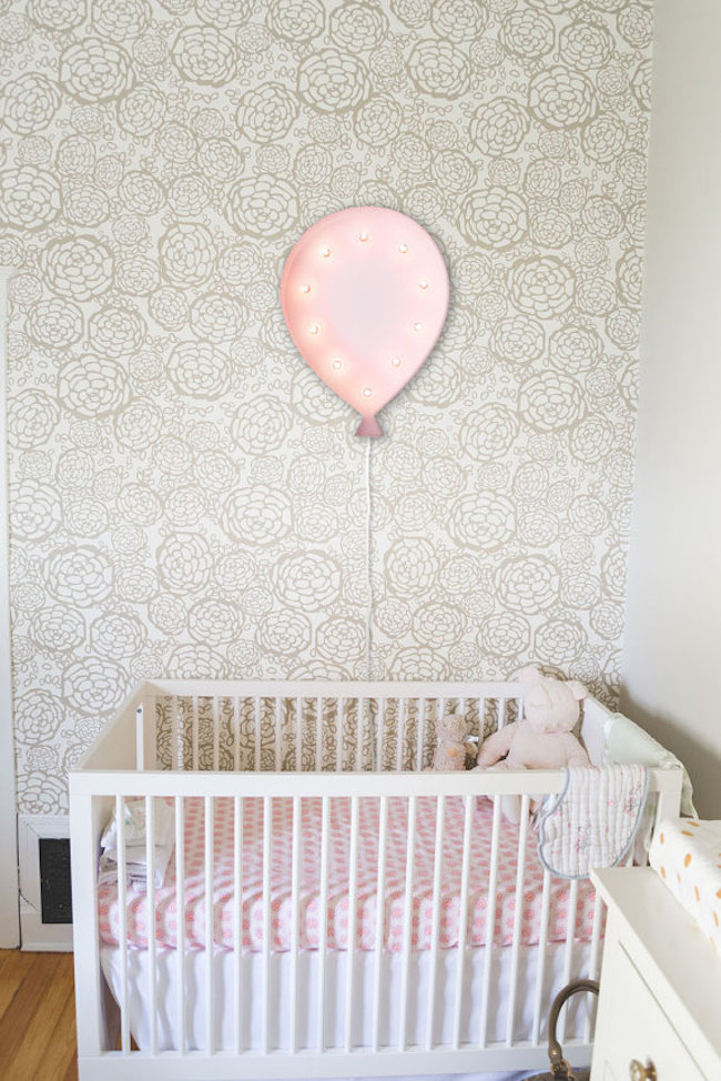Balloon-shaped marquee sign hung above crib