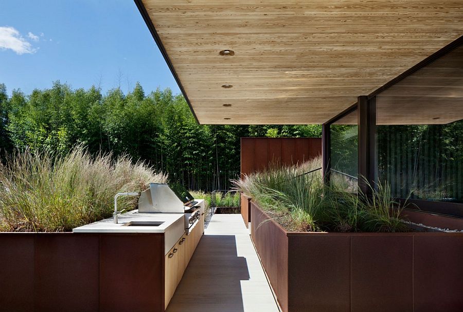Barbeque area of the East Hampton home surrounded by natural greenery