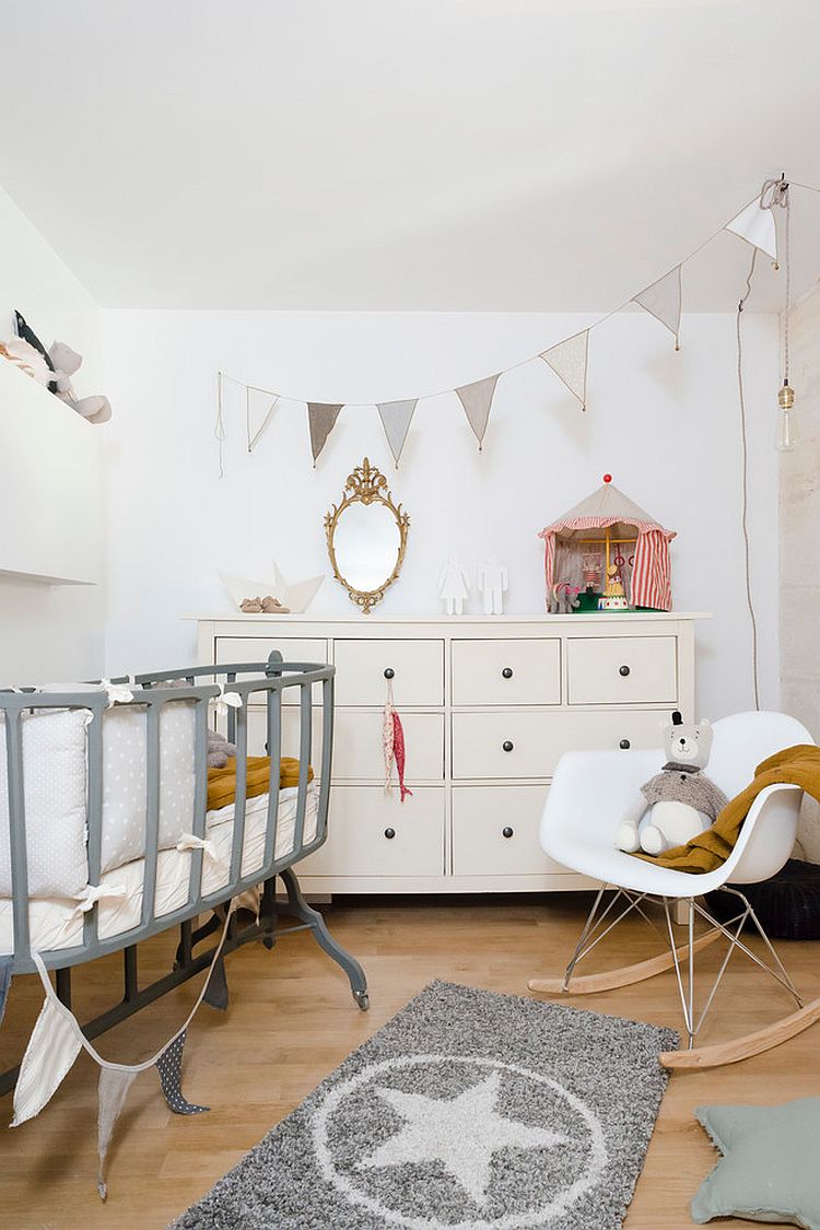 Beautiful bassinet and Eames Rocker add to Scandinavian style of the room