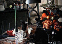 Black-and-orange-Halloween-table-setting-with-lots-of-skulls-217x155