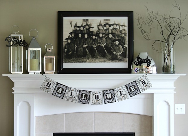 Black and white Halloween fireplace mantel with family photo of witches