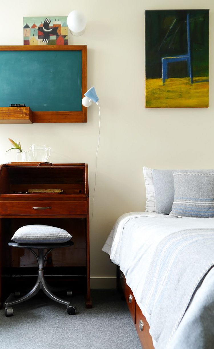 Chalkboard above the small workspace next to the bed