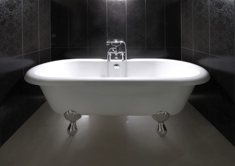 Clawfoot bathtub in a black powder room