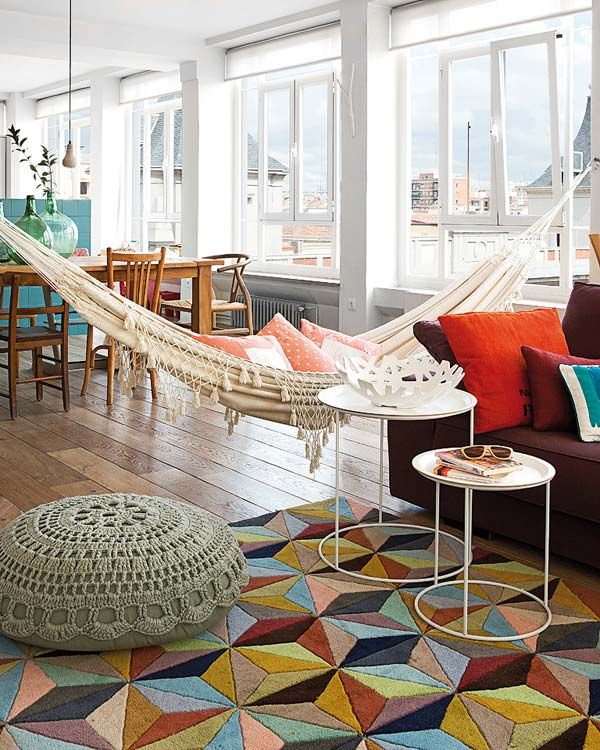 Colorful and bright apartment with a hammock in the living room