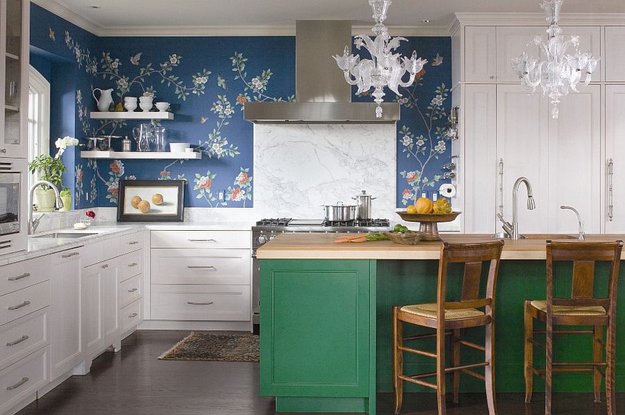 Colorful kitchen island with buther block top, wallpapered wall and marble backsplash come together in this kitchen