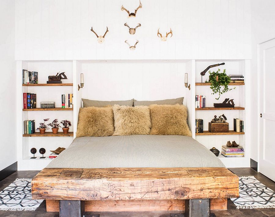 Comfy bedroom with a wooden bench and antlers on the wall