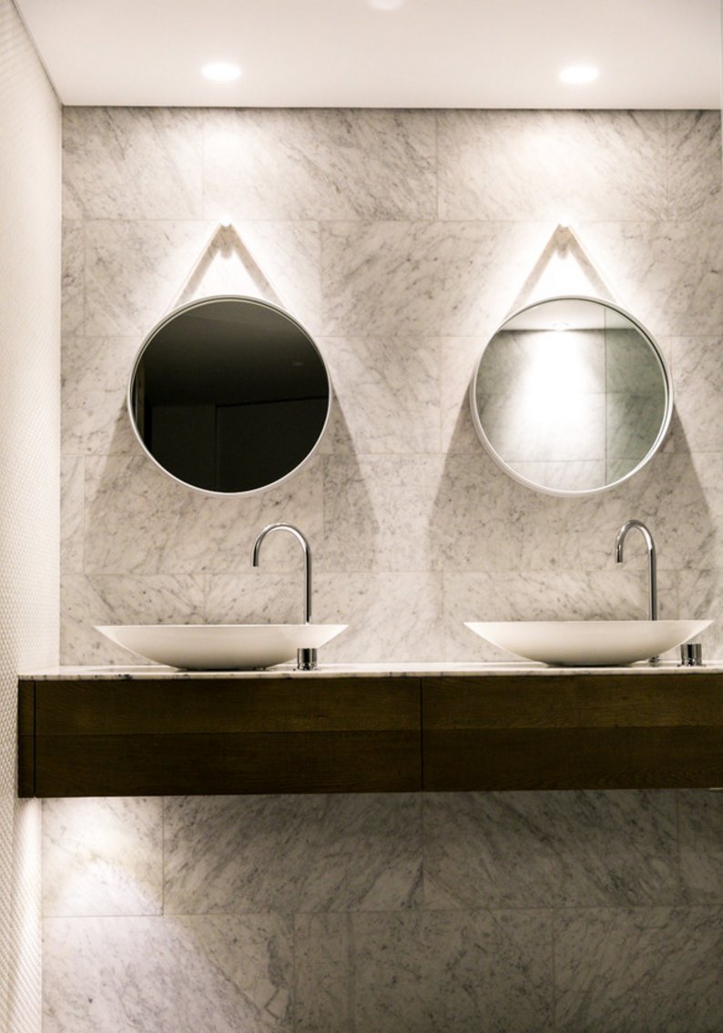 Contemporary bathroom with a pair of round mirrors