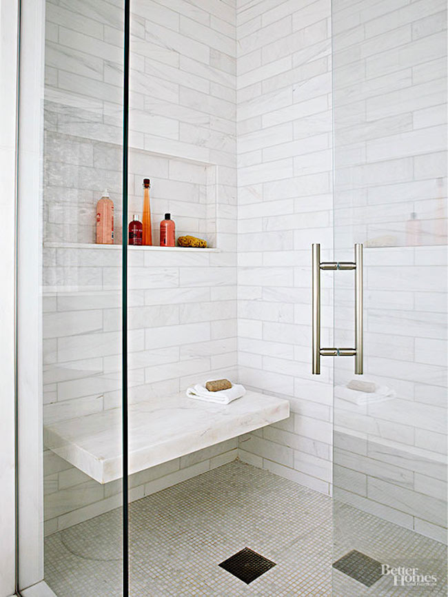 Convenient marble bench built into tiled shower wall