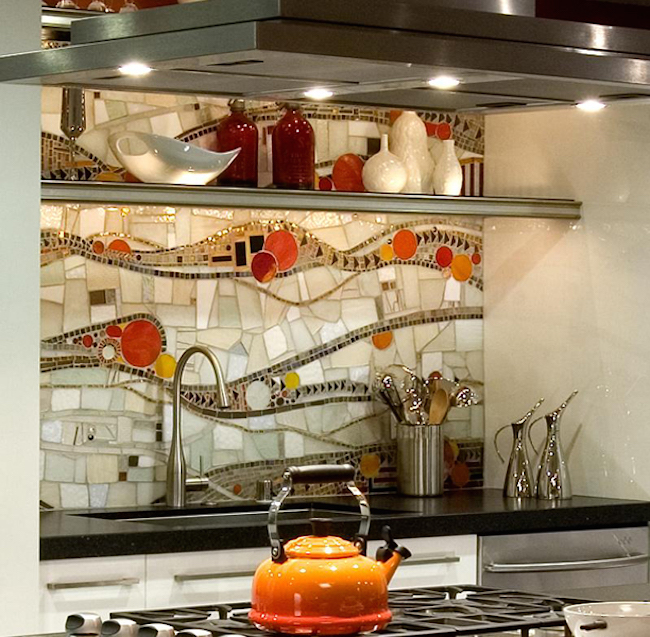 Creative backsplash design with sublte pops of orange and red