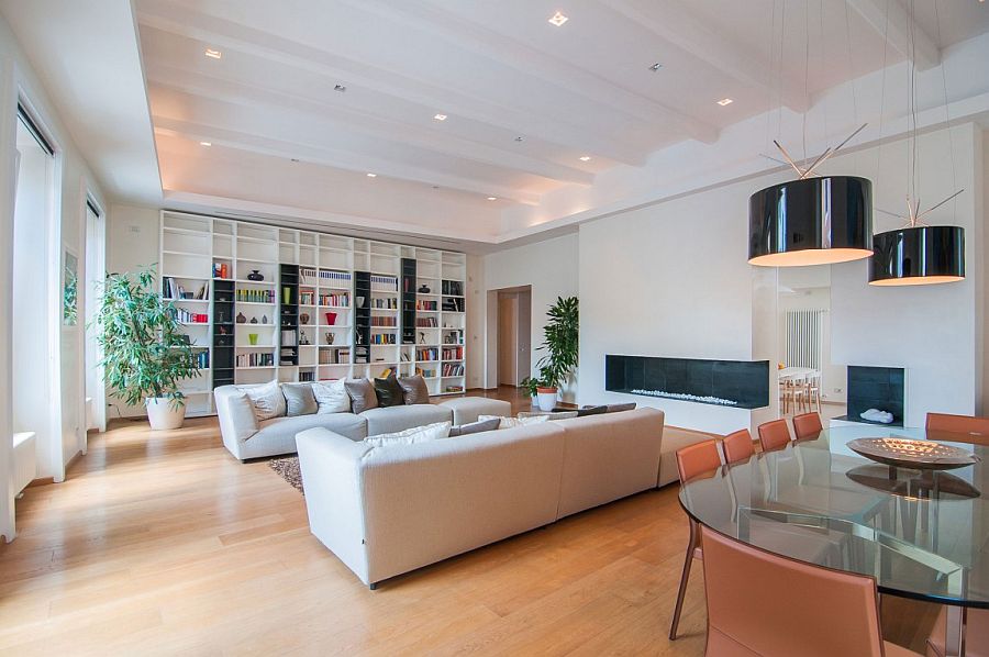 Drum pendants in black above the dining table become a part of the living room visual