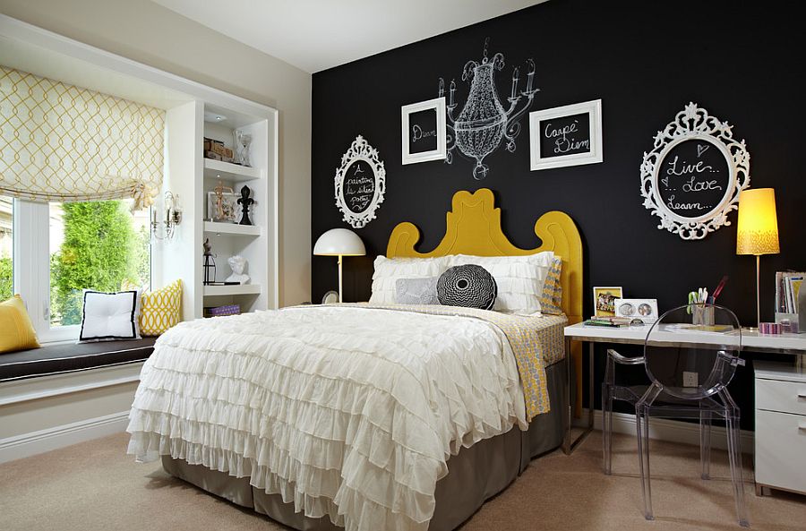 Empty picture frames and chalkboard paint create a vibrat accent wall in the bedroom