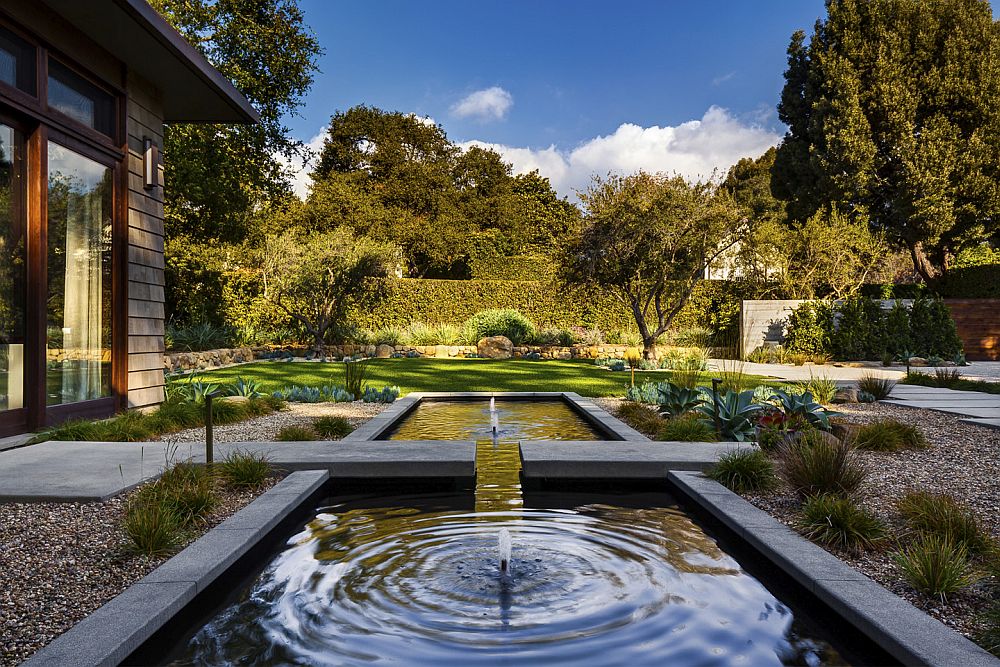 Expansive modern garden with water feature provides a tranquil backyard retreat