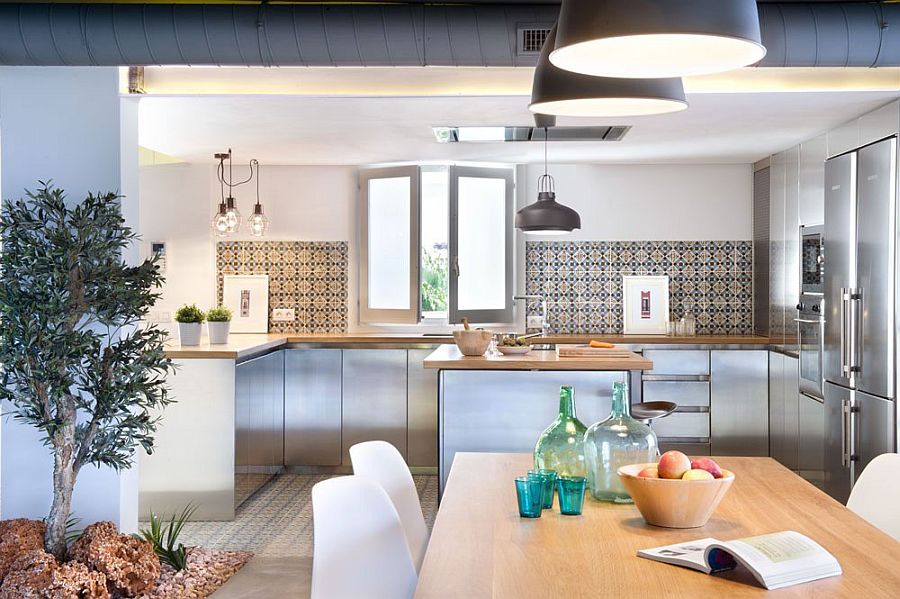 Exposed duct pipes, geometric tiles and industrial style lighting in kitchen