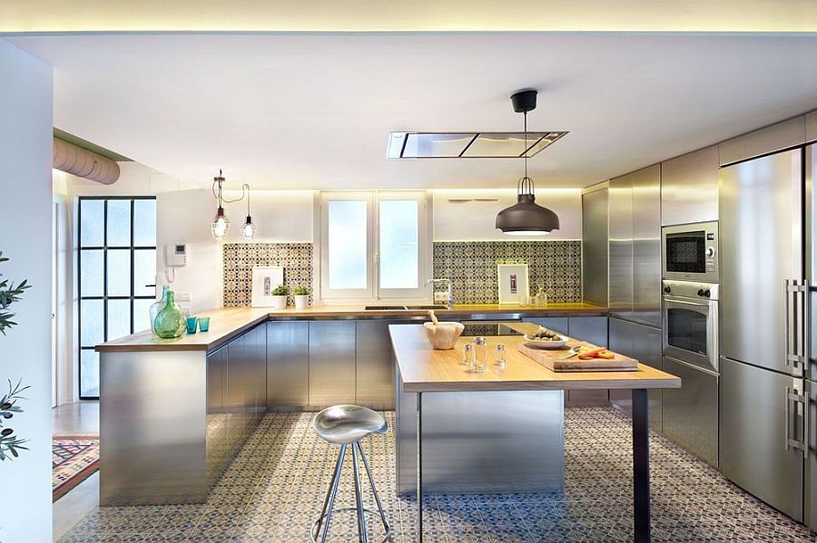 Fascinating use of geometric tiles, stainless steel surfaces and industrial lighting in the kitchen