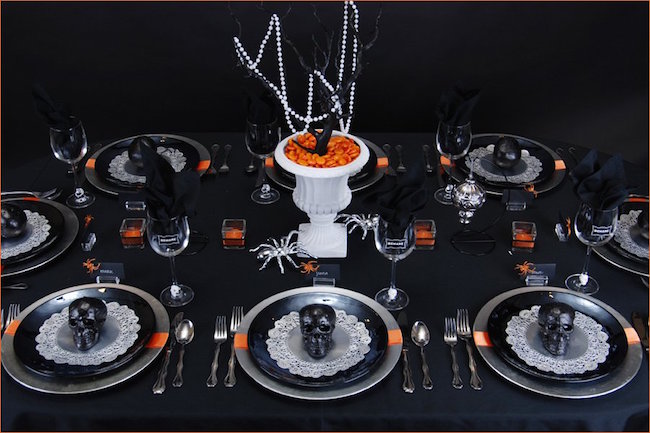 Ghoulish glam Halloween table setting with black skulls