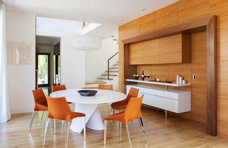 Gorgeous caboche chandelier hangs above the circular dining table in white