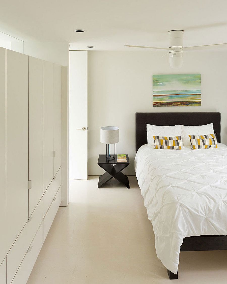 Headboard and nightstand bring black to the all-white bedroom