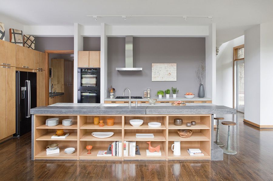 Kitchen island in stone and concrete with open wooden shelves [Design: j witzel interior design]