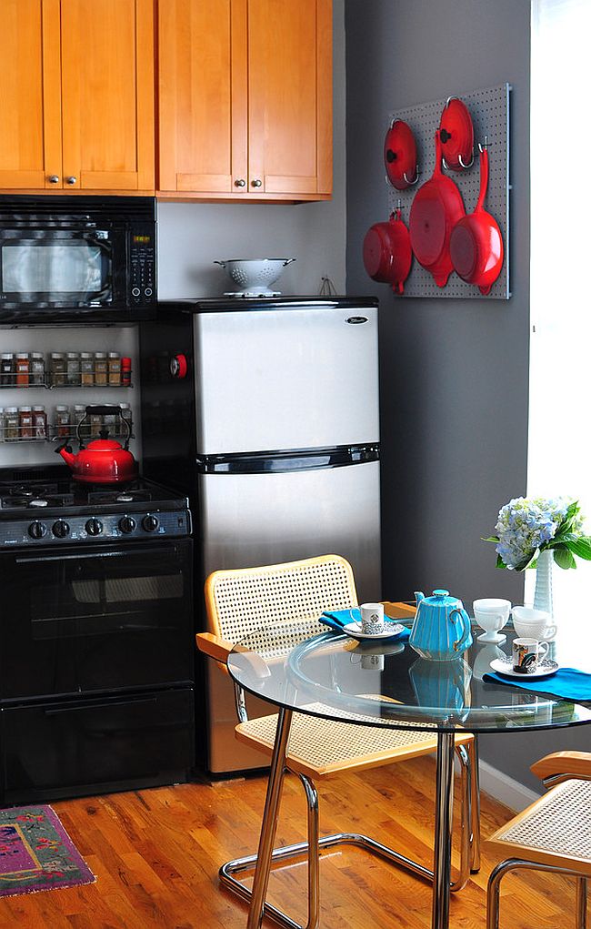 Kitchenware adds bright red to the small kitchen in black and gray