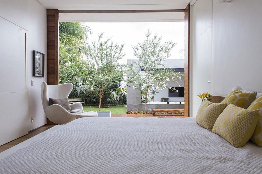 Large glass door connects the bedroom with the wooden deck