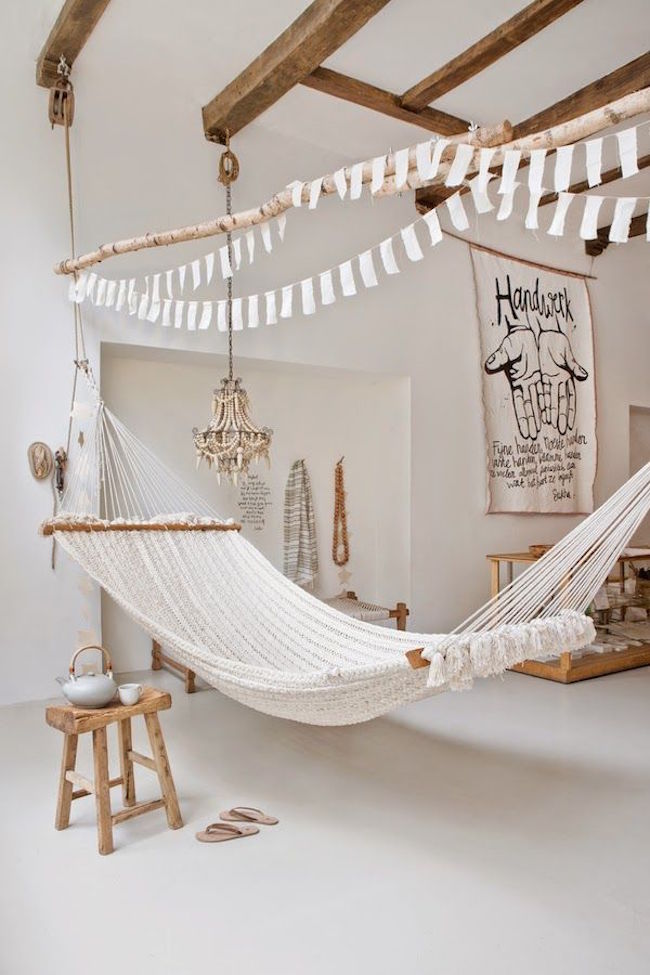 Large hammock in white room with wood accents