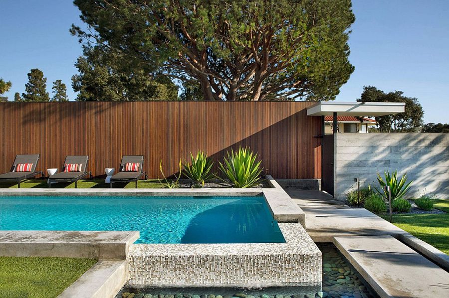 Lovely backyard pool that overflows into the reflection pool