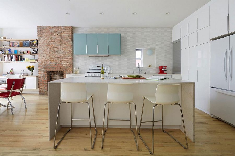 Lower level living area with kitchen, dining and brick wall fireplace