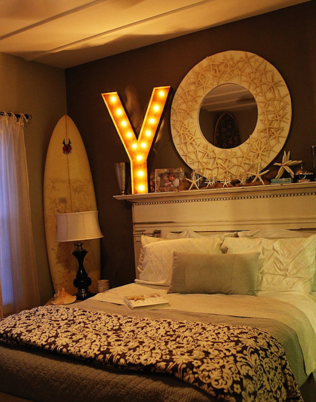 Marquee letter placed over the bed in a bedroom