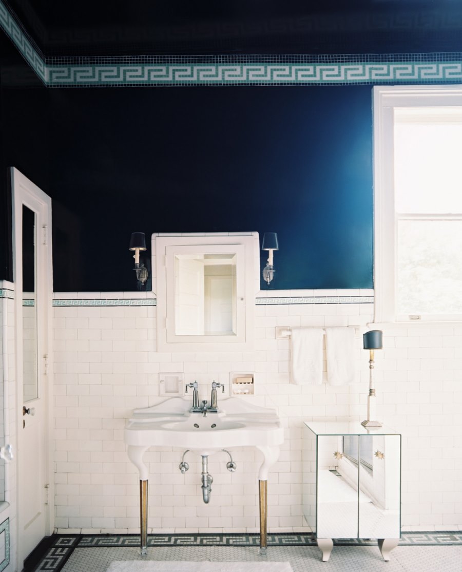 Medicine cabinet flanked by lamps