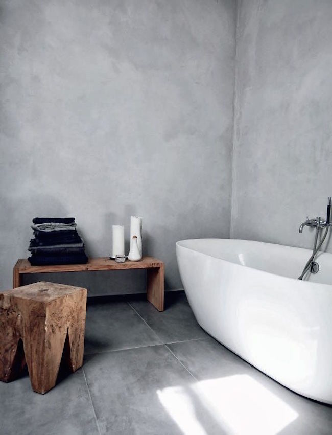 Minimalist bathroom with rustic wood bench and stool