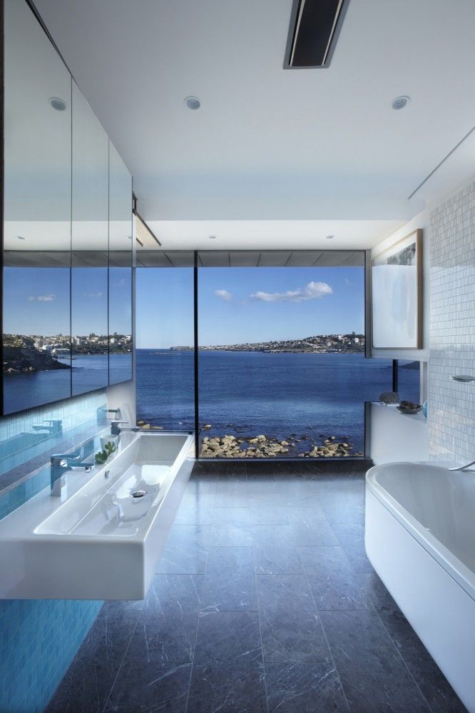 Modern bathroom with a rocky sea view