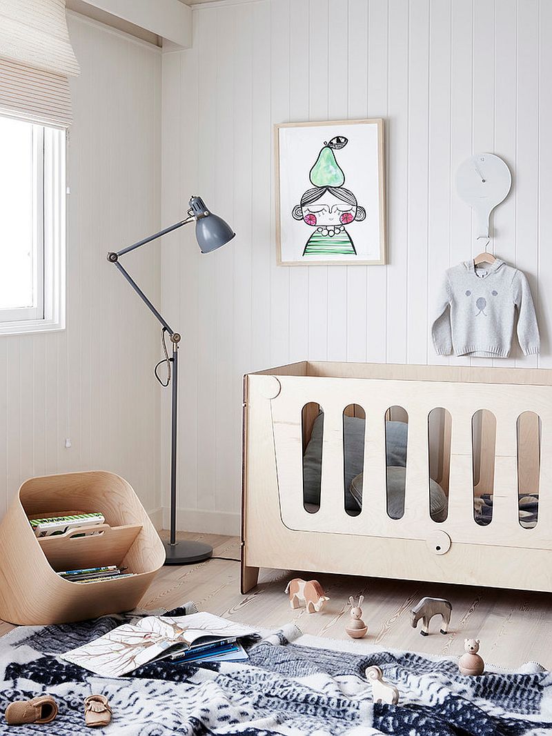 Monochromatic nursery with floor lamp and a contemporary crib