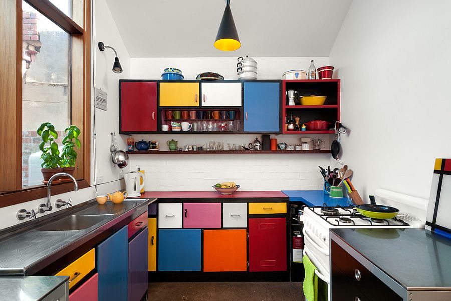 Multi-colored shelves create a fun and dynamic kitchen [Design: Ande Bunbury Architects]