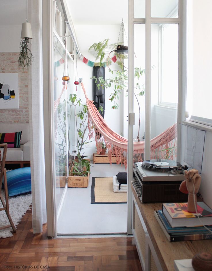 Pink hammock in a sunroom