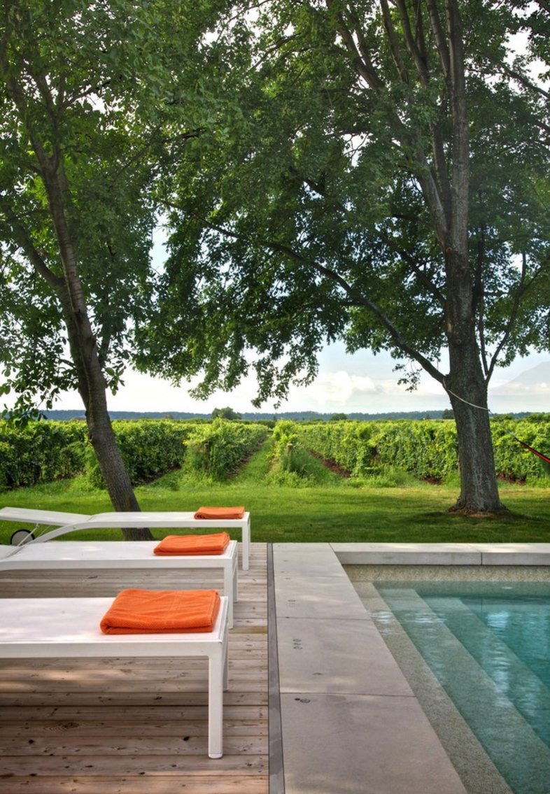 Poolside lounge chairs and orange towels