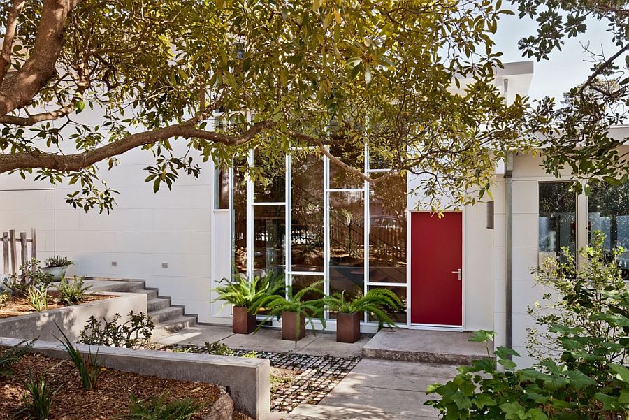 Red door of the Mid-century home adds color to the entrance