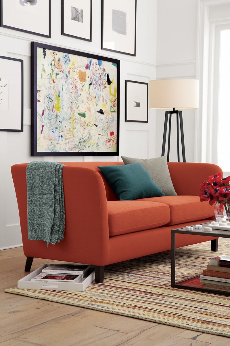 Rust and teal in a living room by Crate & Barrel